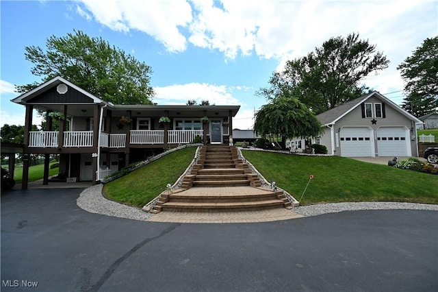 50277 Carroll Rd, East Liverpool, OH 43920 - view of front facade with stairway, a front yard, a detached garage, and a porch