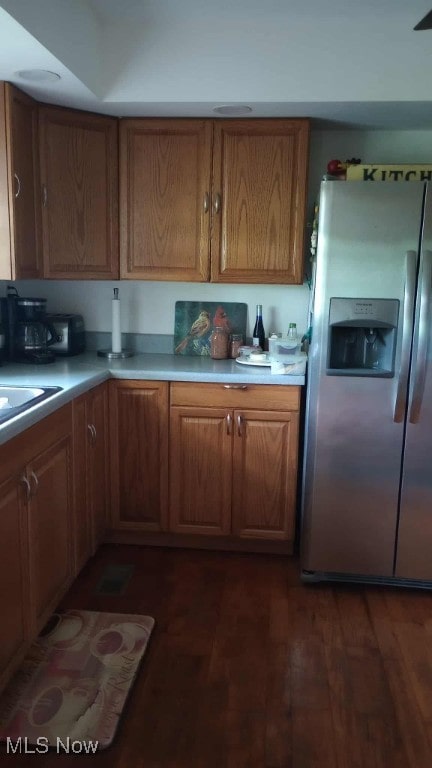 297 Hales Lndg, Elizabeth, WV 26143 - kitchen with stainless steel fridge, dark wood-style flooring, light countertops, and brown cabinetry