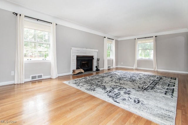 2090 Hadden Rd, Euclid, OH 44117 - living area featuring wood finished floors, a brick fireplace, and baseboards