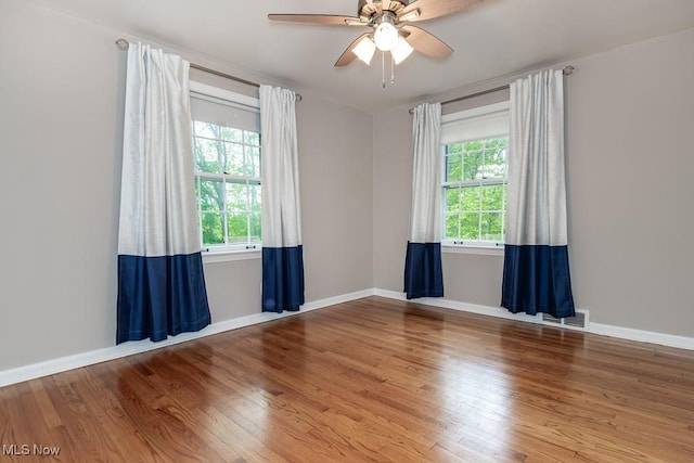 2090 Hadden Rd, Euclid, OH 44117 - spare room featuring wood finished floors, a ceiling fan, and baseboards