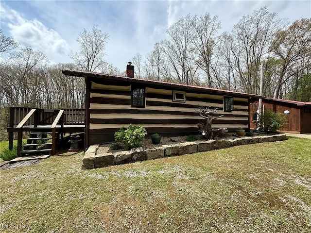 6141 Avon Rd NE, Carrollton, OH 44615 - view of side of property with a chimney, a deck, and a yard