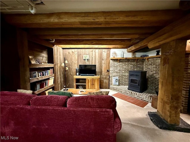 6141 Avon Rd NE, Carrollton, OH 44615 - carpeted living room with a wood stove and beamed ceiling