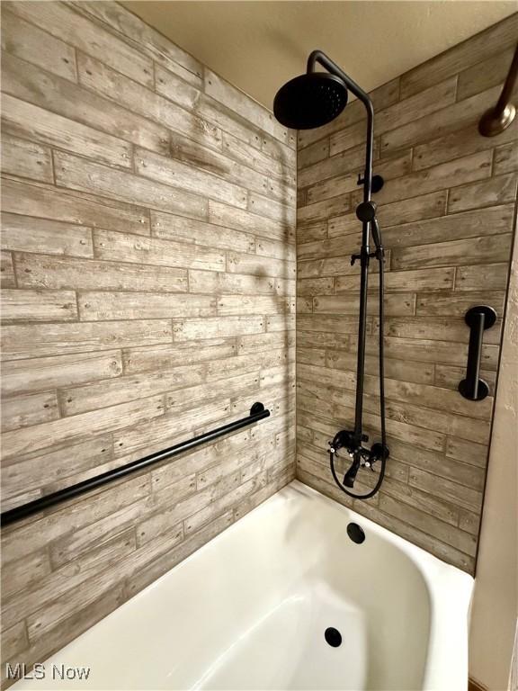 6141 Avon Rd NE, Carrollton, OH 44615 - bathroom with wood walls and shower / washtub combination