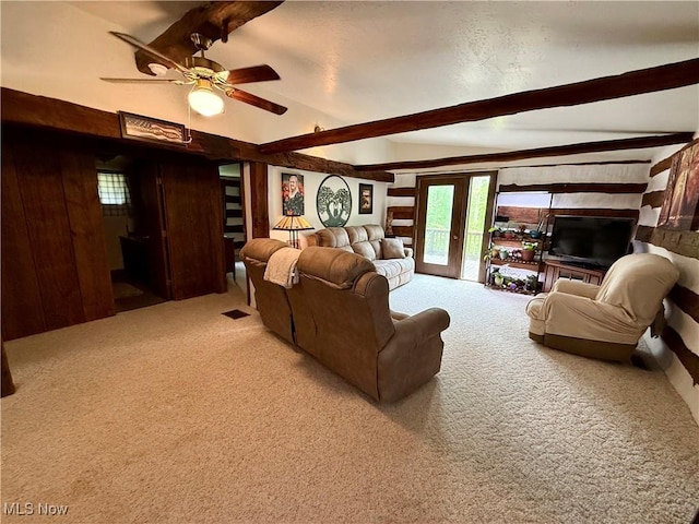 6141 Avon Rd NE, Carrollton, OH 44615 - carpeted living room with beam ceiling, ceiling fan, and wood walls