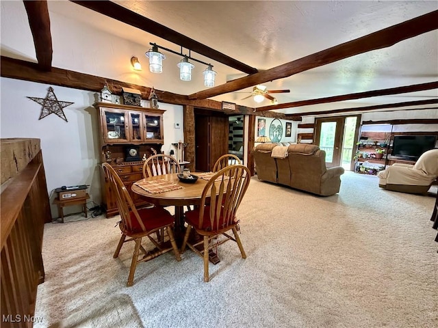 6141 Avon Rd NE, Carrollton, OH 44615 - dining space with beam ceiling, light colored carpet, and a ceiling fan
