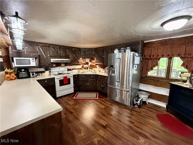 6141 Avon Rd NE, Carrollton, OH 44615 - kitchen featuring white appliances, extractor fan, light countertops, dark brown cabinets, and a textured ceiling