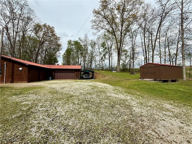 6141 Avon Rd NE, Carrollton, OH 44615 - view of grassy yard featuring a detached garage and an outbuilding