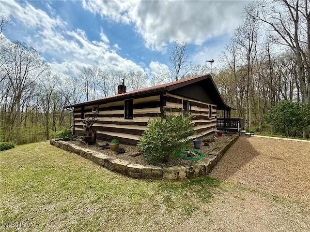 6141 Avon Rd NE, Carrollton, OH 44615 - view of home's exterior featuring a chimney, a lawn, and a deck