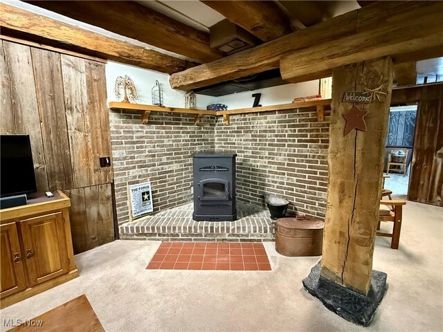 6141 Avon Rd NE, Carrollton, OH 44615 - unfurnished living room featuring a wood stove, carpet, heating unit, and wood walls