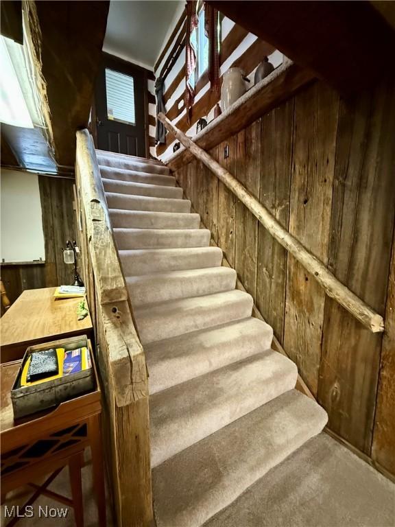 6141 Avon Rd NE, Carrollton, OH 44615 - stairs featuring wood walls and carpet floors