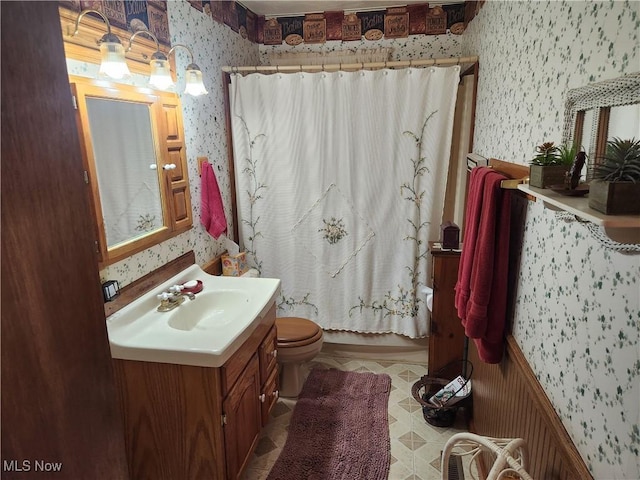 867 S 14th St, Sebring, OH 44672 - bathroom featuring wallpapered walls, vanity, toilet, and shower / bath combination with curtain