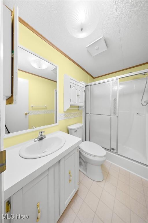 8 Maple Dr, Olmsted Twp, OH 44138 - bathroom with a shower stall, vanity, toilet, a textured ceiling, and tile patterned floors