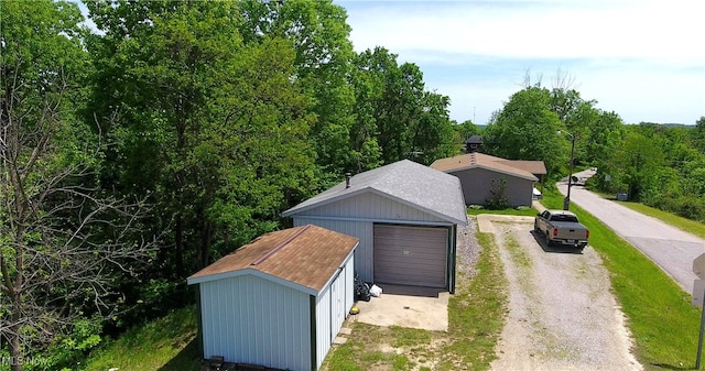 728 Rising Sun Ridge Rd, Walker, WV 26180 - garage with driveway and a wooded view