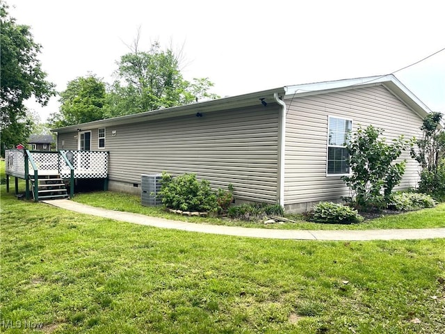 728 Rising Sun Ridge Rd, Walker, WV 26180 - view of side of home with crawl space, a wooden deck, central air condition unit, and a lawn