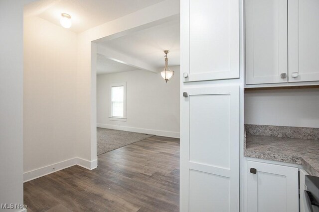 1197 E Ave, Akron, OH 44307 - kitchen with baseboards, dark wood-style flooring, white cabinetry, and hanging light fixtures