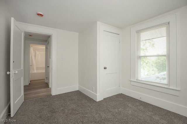 1197 E Ave, Akron, OH 44307 - unfurnished bedroom featuring carpet flooring, baseboards, and a closet