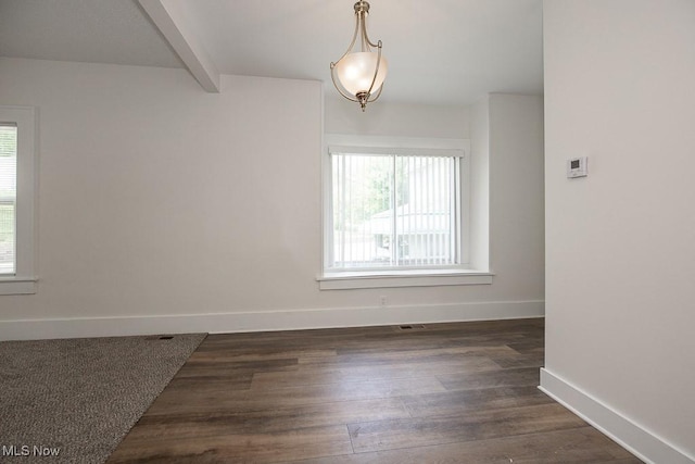 1197 E Ave, Akron, OH 44307 - spare room featuring healthy amount of natural light, baseboards, dark wood-type flooring, and beamed ceiling
