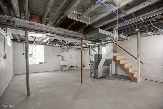 1197 E Ave, Akron, OH 44307 - below grade area featuring heating unit, stairs, and a sink