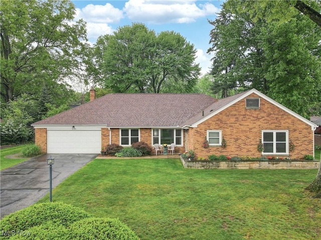 891 Sovereign Rd, Akron, OH 44303 - ranch-style house with brick siding, driveway, a garage, a front lawn, and a chimney