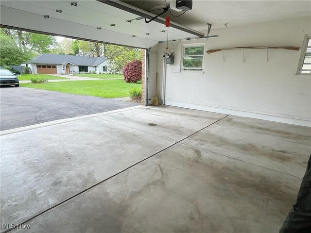 891 Sovereign Rd, Akron, OH 44303 - garage featuring a garage door opener and a ceiling fan
