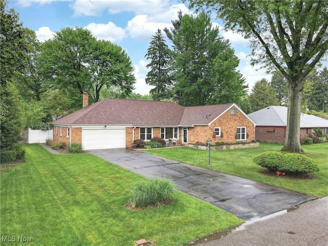 891 Sovereign Rd, Akron, OH 44303 - single story home featuring brick siding, a garage, driveway, a chimney, and roof with shingles