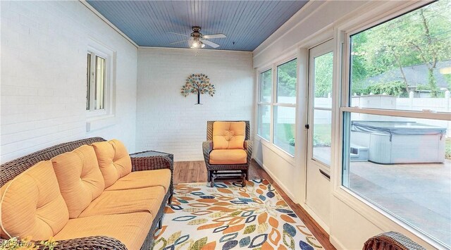 891 Sovereign Rd, Akron, OH 44303 - sunroom featuring brick wall, wood finished floors, and a jacuzzi