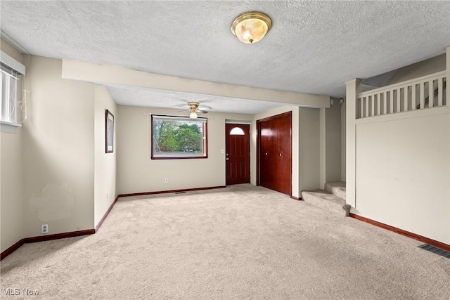 2021 17th St NE, Canton, OH 44705 - spare room with carpet floors, a textured ceiling, baseboards, and ceiling fan