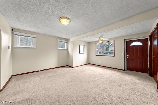 2021 17th St NE, Canton, OH 44705 - entryway with carpet floors, ceiling fan, a textured ceiling, and baseboards