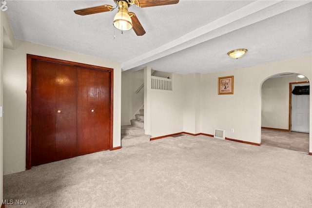 2021 17th St NE, Canton, OH 44705 - unfurnished bedroom with arched walkways, carpet floors, a closet, baseboards, and a ceiling fan