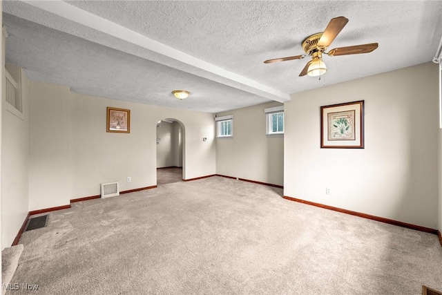 2021 17th St NE, Canton, OH 44705 - spare room featuring arched walkways, carpet flooring, and baseboards
