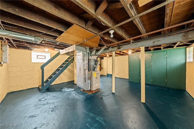 2021 17th St NE, Canton, OH 44705 - basement featuring heating unit, stairway, and concrete block wall