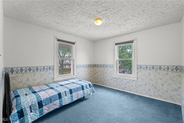 2021 17th St NE, Canton, OH 44705 - carpeted bedroom with a wainscoted wall and a textured ceiling