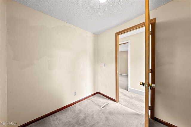 2021 17th St NE, Canton, OH 44705 - carpeted spare room with baseboards and a textured ceiling