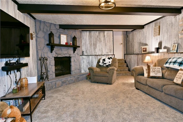 carpeted living area with wood walls, beamed ceiling, and a fireplace