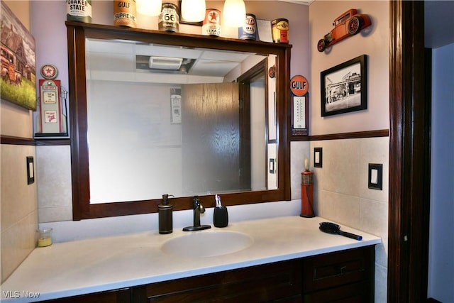 bathroom featuring vanity and tile walls