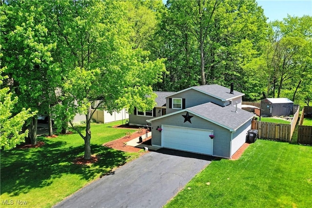 view of front facade with roof with shingles and driveway