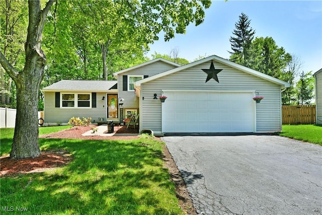 tri-level home with an attached garage and driveway