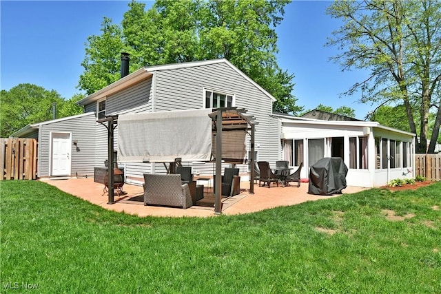 rear view of house featuring a sunroom and a patio area
