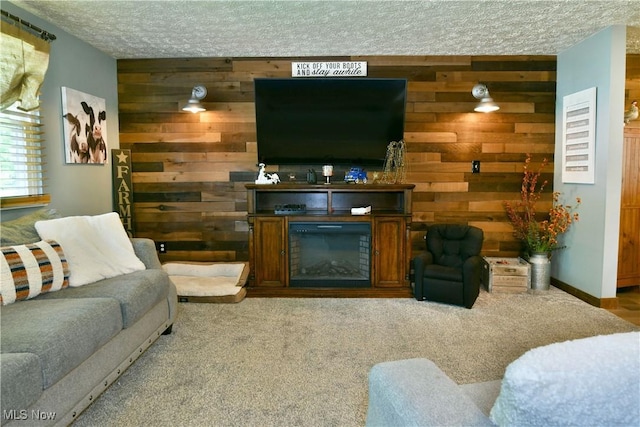 living room with wooden walls, a textured ceiling, and carpet flooring