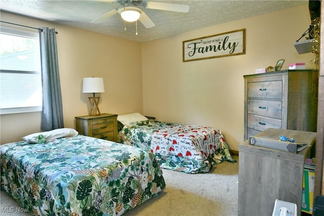 carpeted bedroom with a textured ceiling and a ceiling fan
