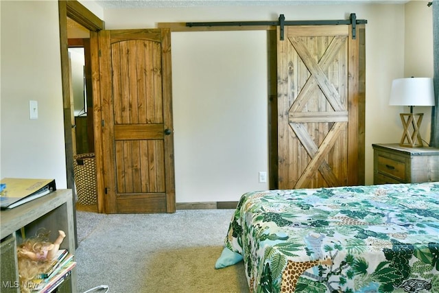 carpeted bedroom with a barn door
