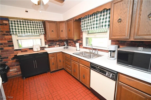 252 Rosemont Ave, Youngstown, OH 44515 - kitchen with white dishwasher, a sink, light countertops, and brick patterned flooring