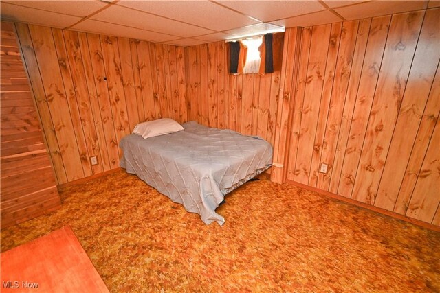 252 Rosemont Ave, Youngstown, OH 44515 - bedroom with a paneled ceiling, baseboards, carpet flooring, and wood walls