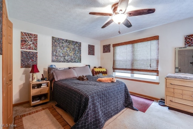 75 River Ridge Lane, Munroe Falls, OH 44262 - carpeted bedroom with baseboards, a textured ceiling, and a ceiling fan