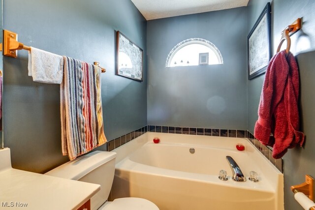 75 River Ridge Lane, Munroe Falls, OH 44262 - bathroom featuring a garden tub, toilet, and vanity