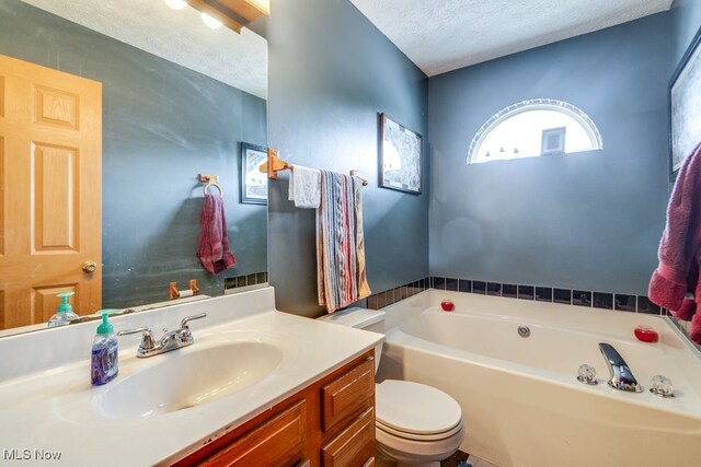 75 River Ridge Lane, Munroe Falls, OH 44262 - full bath featuring a garden tub, a textured ceiling, vanity, and toilet