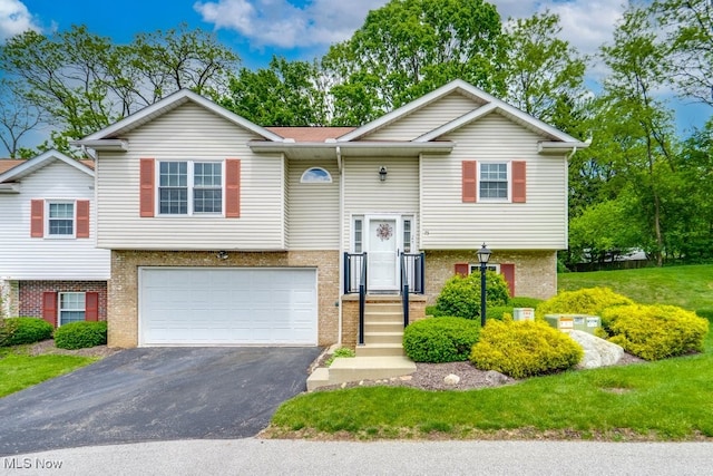 75 River Ridge Lane, Munroe Falls, OH 44262 - split foyer home with driveway, an attached garage, and brick siding