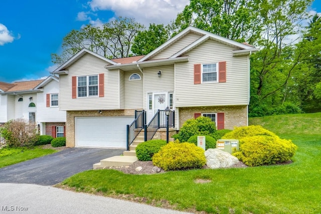 75 River Ridge Lane, Munroe Falls, OH 44262 - bi-level home featuring brick siding, asphalt driveway, a garage, and a front lawn