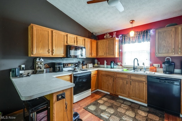 75 River Ridge Lane, Munroe Falls, OH 44262 - kitchen with black appliances, a sink, a textured ceiling, a peninsula, and light countertops