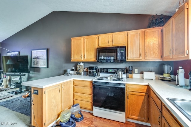 75 River Ridge Lane, Munroe Falls, OH 44262 - kitchen featuring electric stove, black microwave, vaulted ceiling, light countertops, and a peninsula